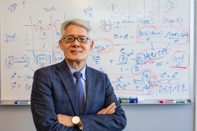 person standing in front of white board 