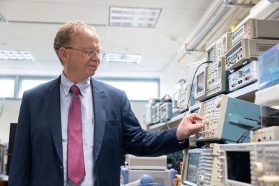 Jeff Reed turns a dial on a piece of lab equipment.