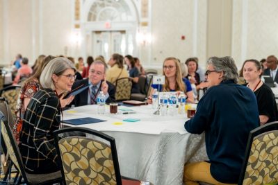 Symposium attendees discuss rural health disparties during World Café-style discussions. Photo by Clayton Metz for Virginia Tech.