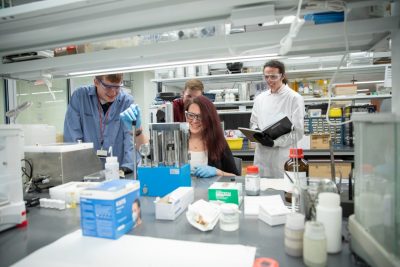 students and faculty work in materials science lab 