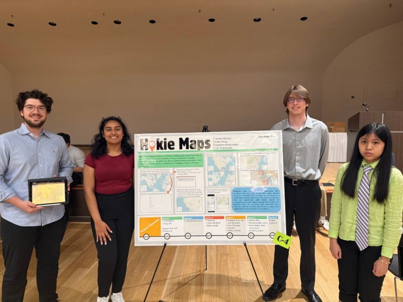 Students in front of research poster.