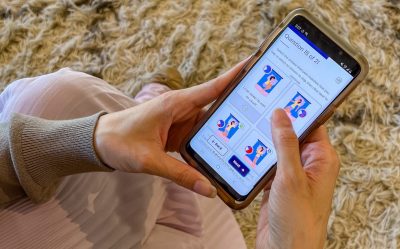 Close up view of person using LiteraSeed software on a mobile phone.