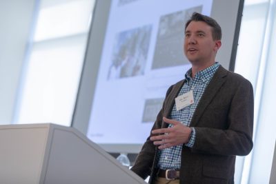 person standing at podium speaking