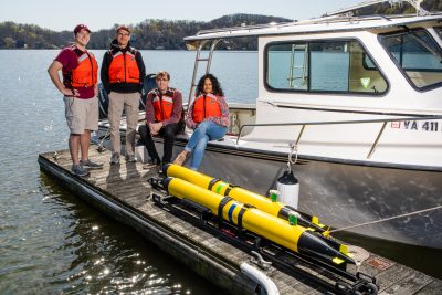 Research team poses in front of boat at Claytor Lake