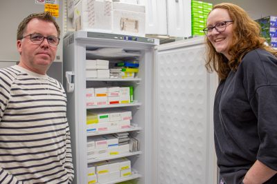 Between Warren Booth (at left) and Lindsay Miles (at right) is one of several refrigerators filled with samples of bed bugs collected from all over the world.