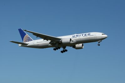 A united airlines airplane flying in the air.