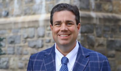 Cayce Myers smiling in a blue jacket. Photo courtesy Virginia Tech