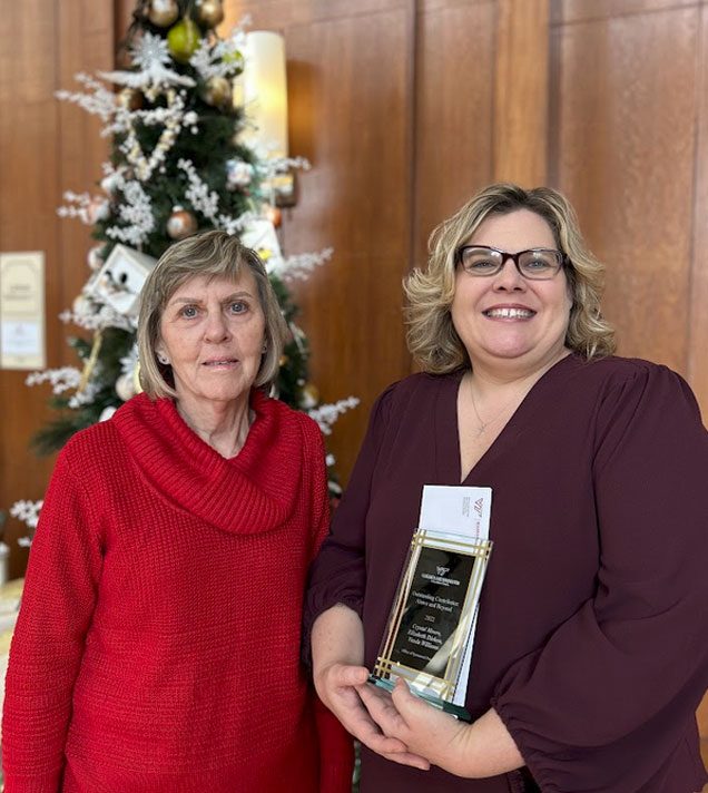 Elizabeth Dishon and Crystal Moore, team members of the proposal and award setup team which were recepients of the Outstanding Contributor: Above and Beyond Award.  Not pictured: Vanda Williams.