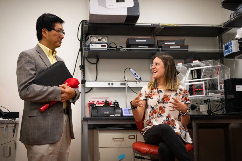 A Virginia Tech student talks with Virginia Tech's Senior Vice President and Chief Innovation Officer Dan Sui about her research in the Davalos Laboratory. Photo by Eleanor Nelson.