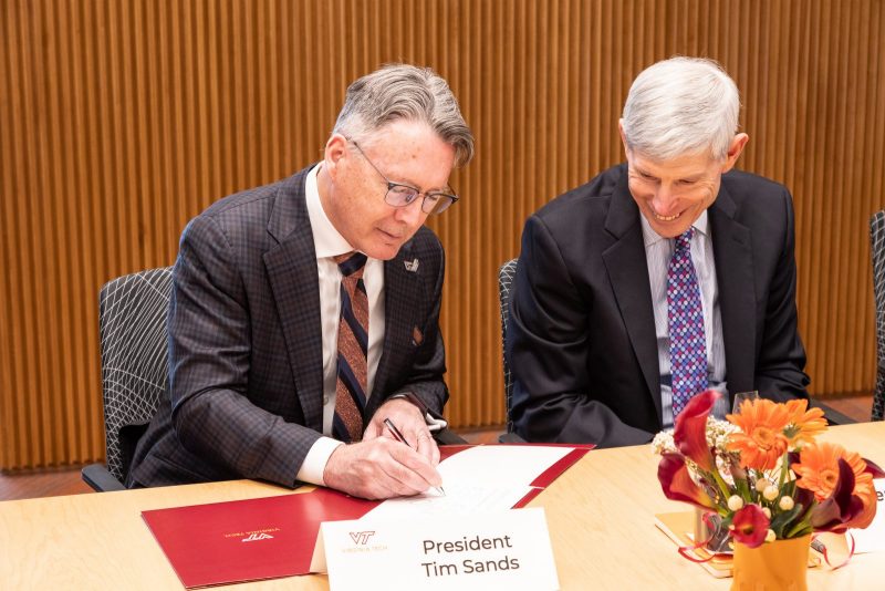 Virginia Tech President Tim Sands (at left) signs the memorandum of understanding with Institute for Defense Analyses President Norton A. Schwartz. Photo by Anthony Wright for Virginia Tech.